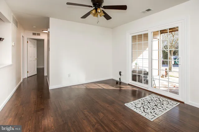 a view of a living room with kitchen island granite countertop wooden floor