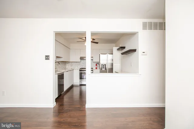 a kitchen with stainless steel appliances granite countertop a sink and a refrigerator