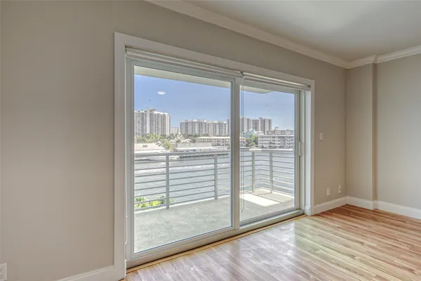 a view of kitchen with wooden floor electronic appliances and window
