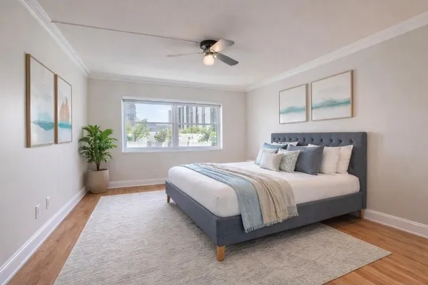 a view of a kitchen with wooden floor and a ceiling fan
