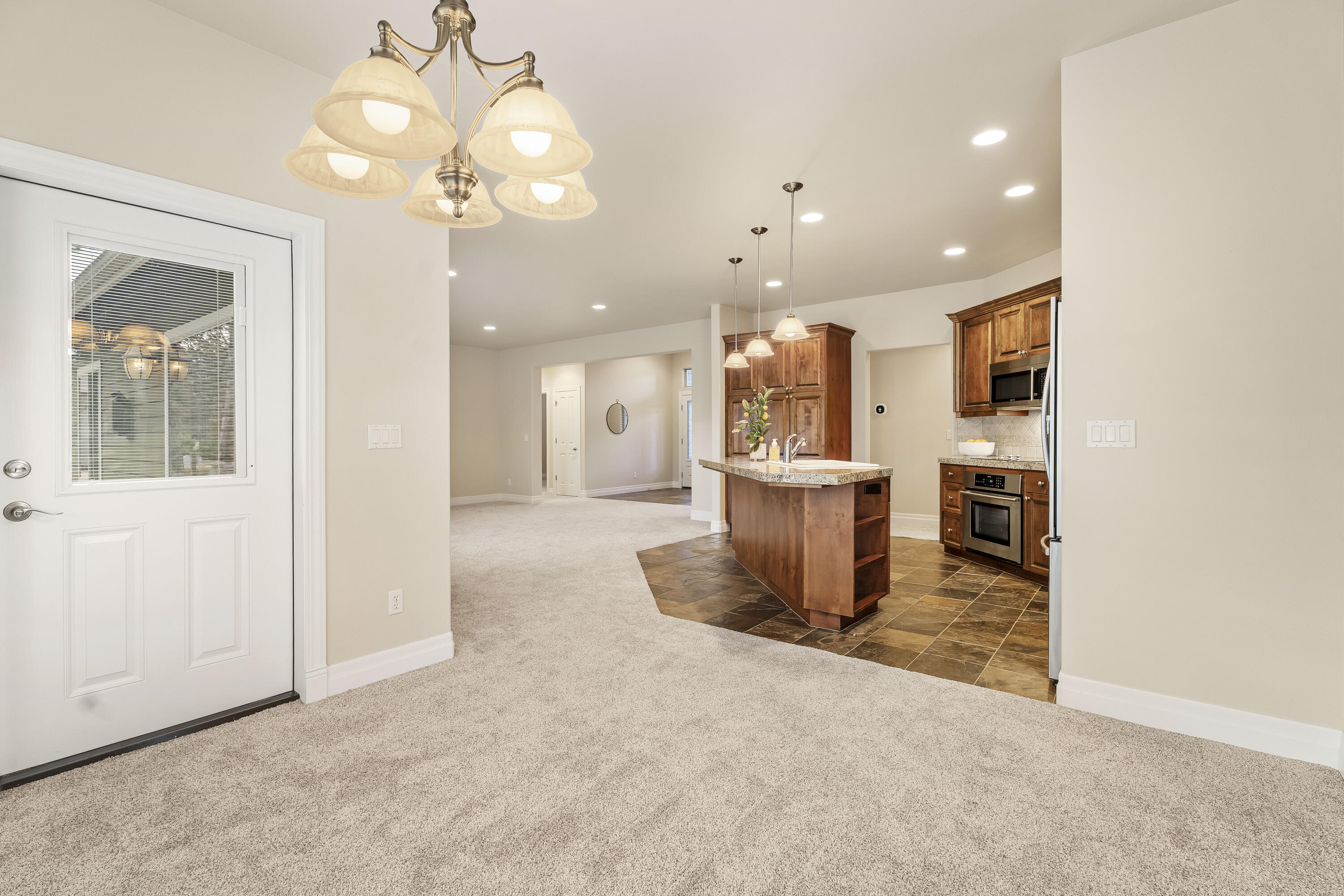 784 Ribbon Falls Road Redmond, OR 97756 - Photo 30 of 79 a view of a kitchen with a refrigerator and a fireplace