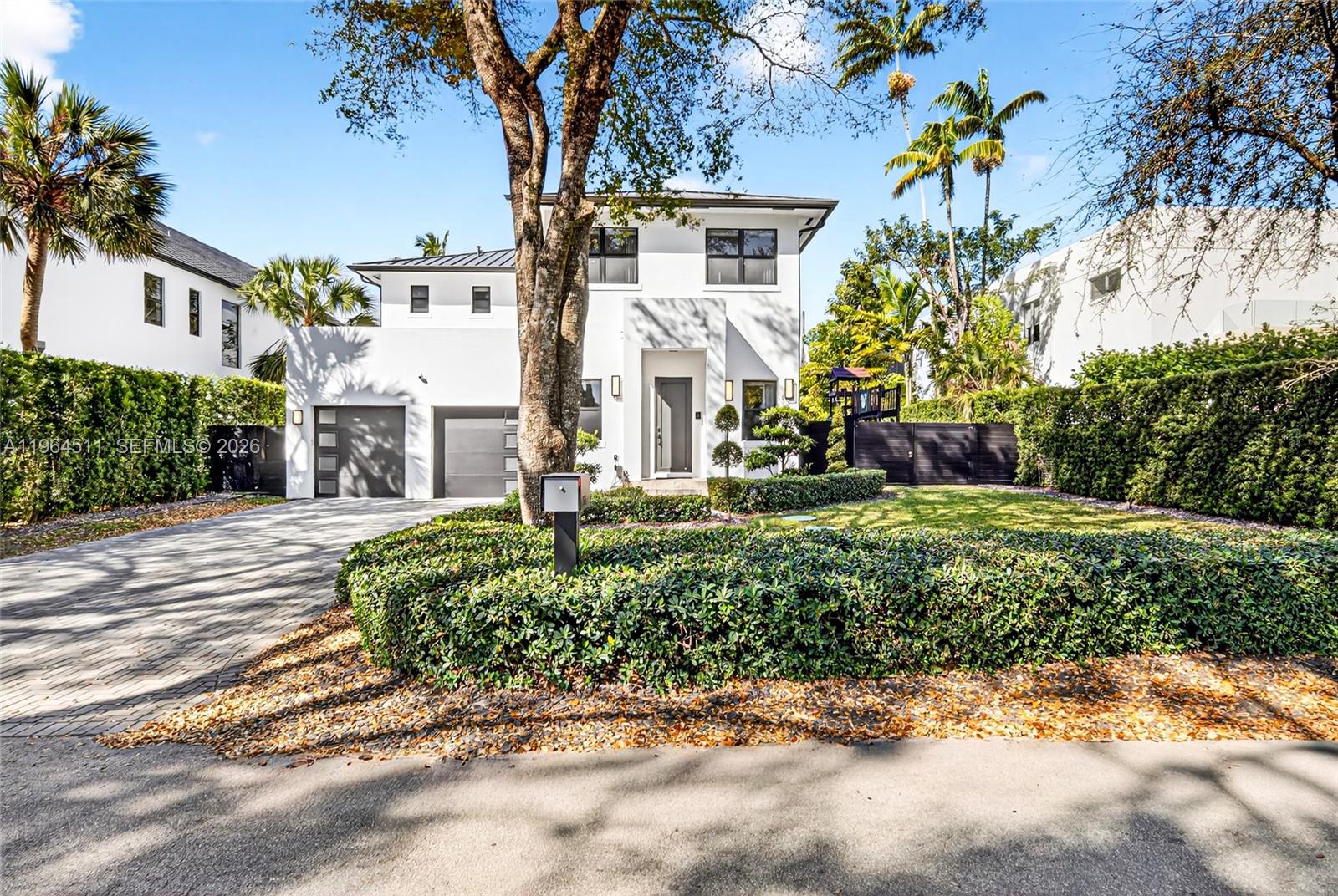 7500 Southwest 55th Avenue Miami, FL 33143 - Photo 2 of 48 a front view of a house with a yard