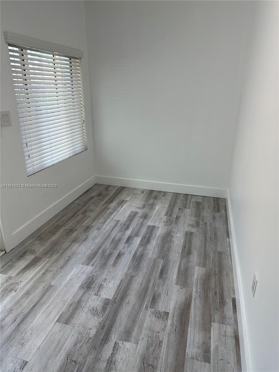 2900 Southwest 4th Street, Unit 2900 Miami, FL 33135 - Photo 2 of 4 a view of wooden floor and window in a room