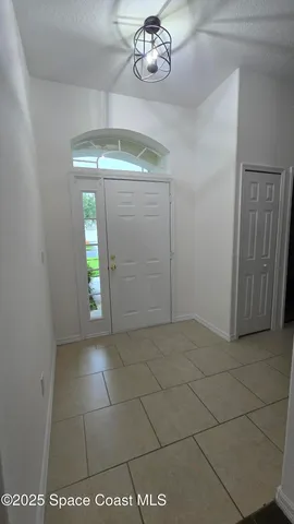 a view of an empty room and a window