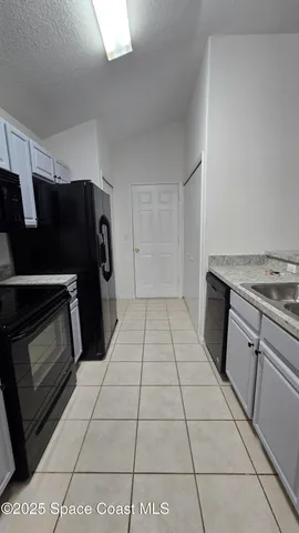 a kitchen with a stove top oven and cabinets