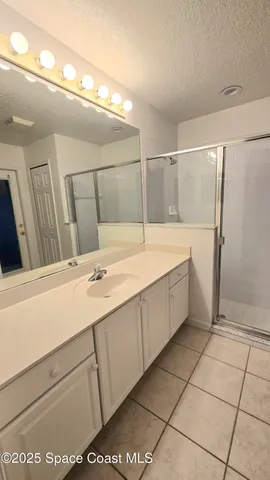 a bathroom with a sink a mirror and a shower