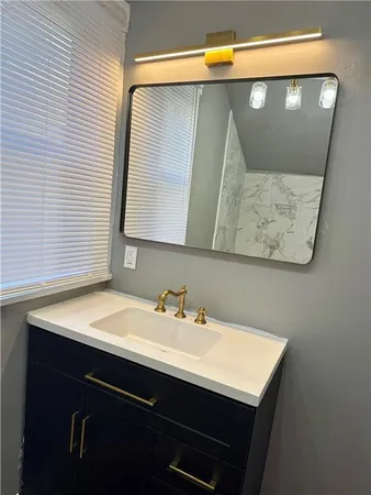 a bathroom with a shower and a sink