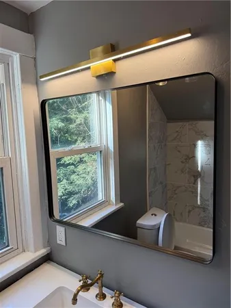 a white toilet sitting next to a bath tub