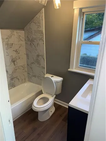 a bathroom with a bathtub and shower