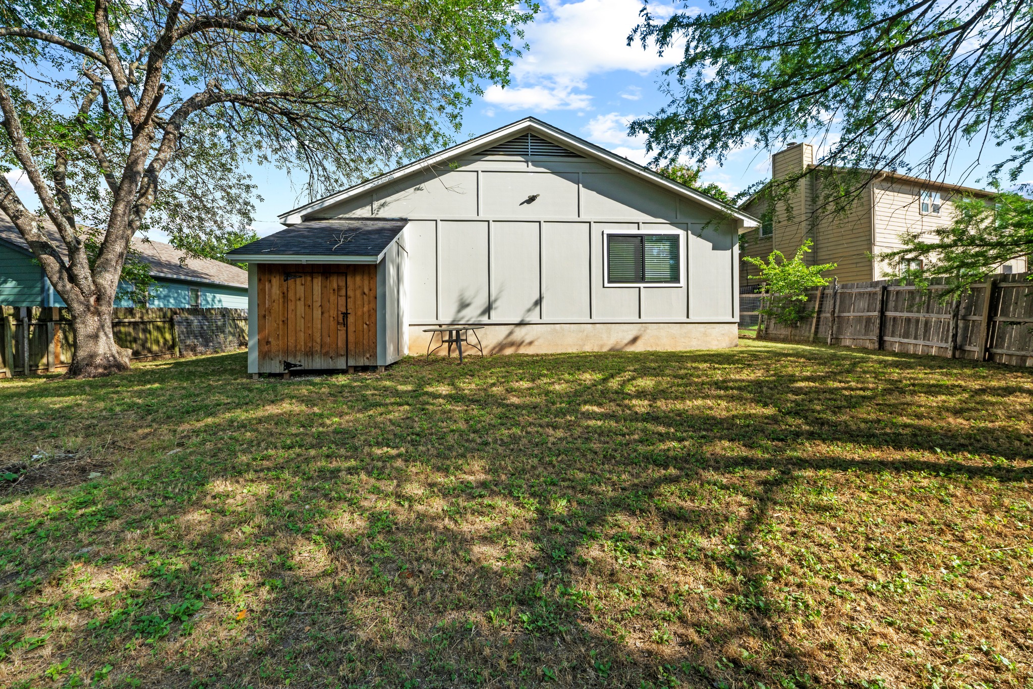 11811 Rotherham Drive Austin, TX 78754 - Photo 32 of 37 A well-maintained side yard offers ample green space and a handy storage shed.