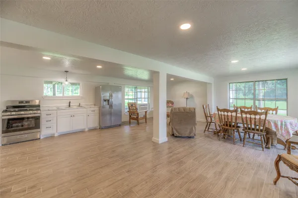 a view of empty room with wooden floor and outdoor view
