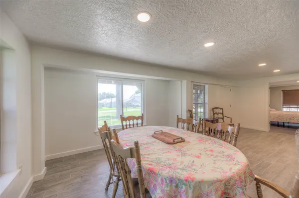 a large white dining space with furniture