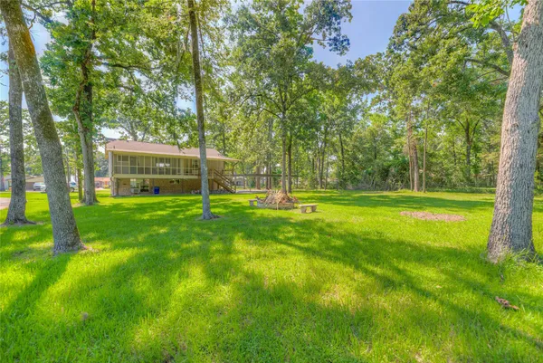 a view of a house with a yard and a tree