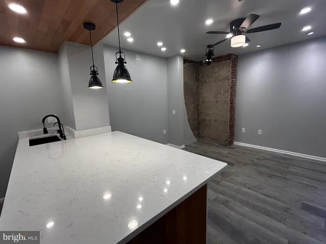 a view of a hallway with a couch and chandelier
