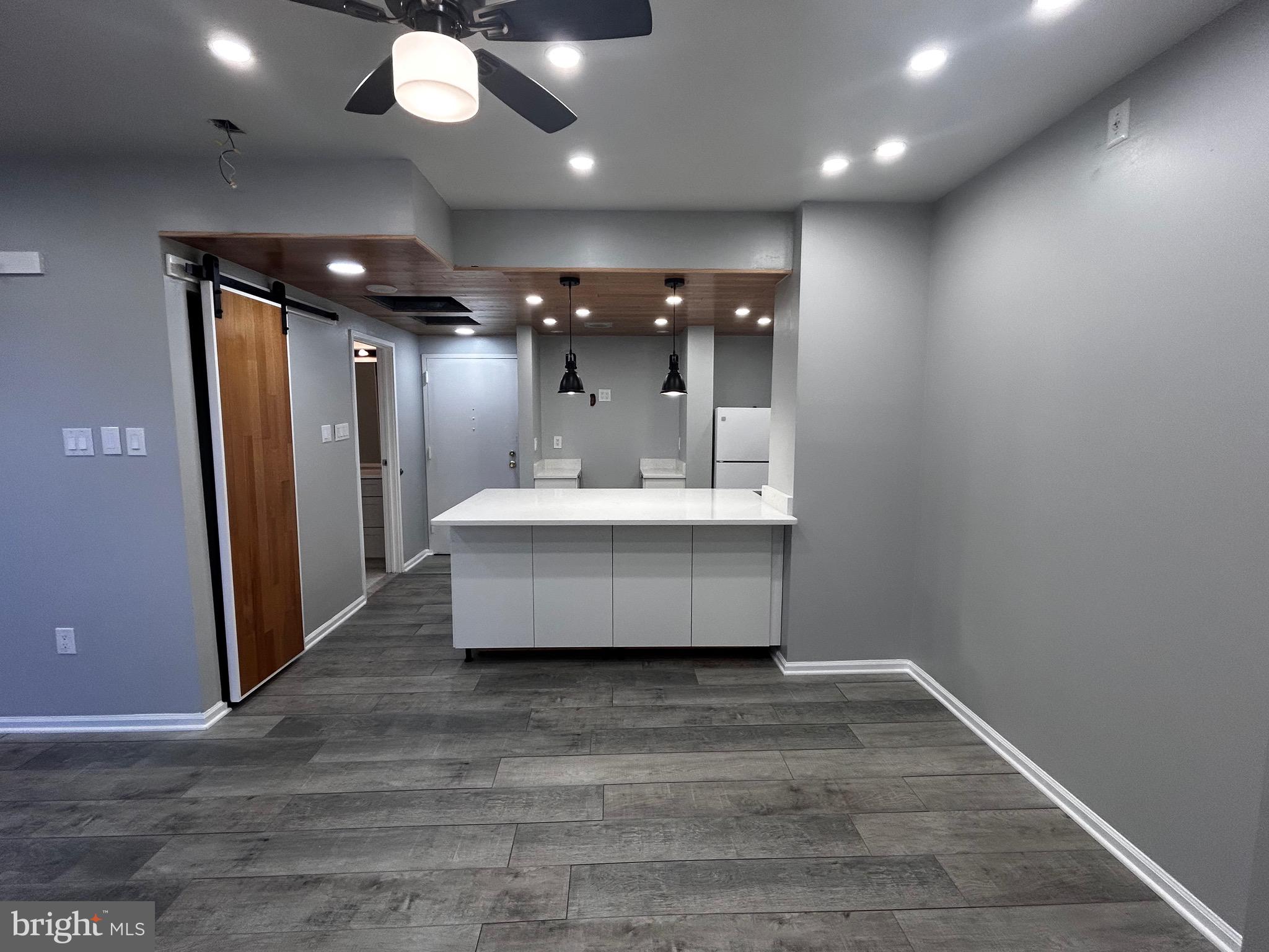 1601 Spring Garden Street, Unit 502 Philadelphia, PA 19130 - Photo 13 of 18 a view of a hallway with a couch and chandelier