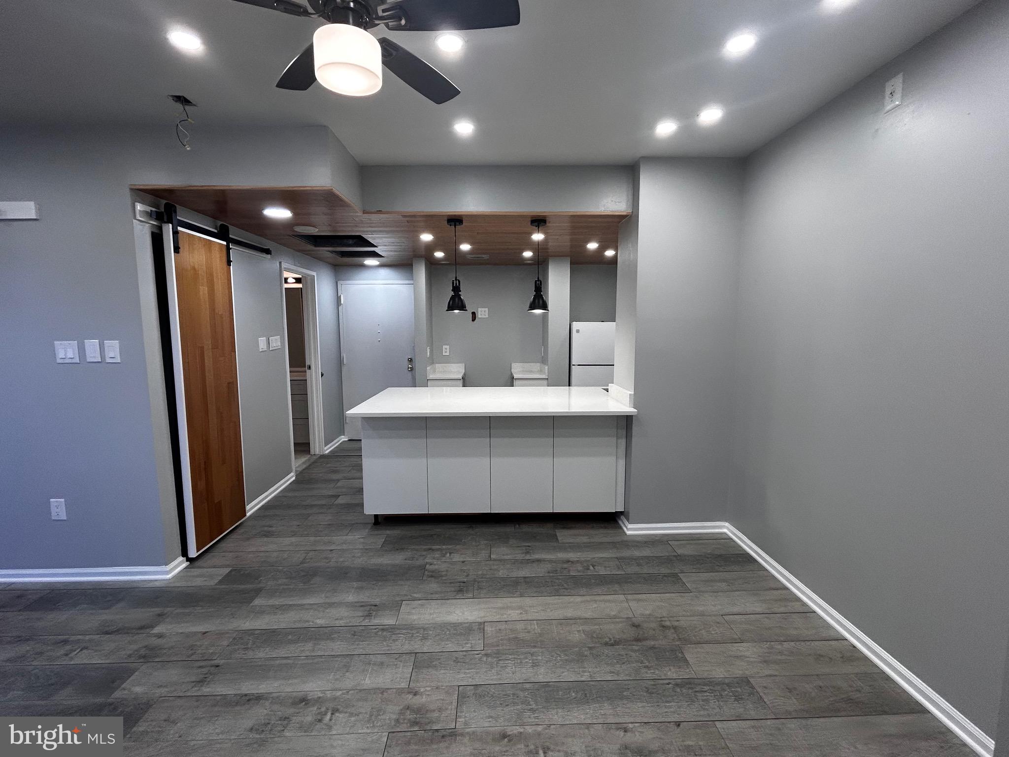 1601 Spring Garden Street, Unit 502 Philadelphia, PA 19130 - Photo 14 of 18 a view of a hallway with a couch and chandelier