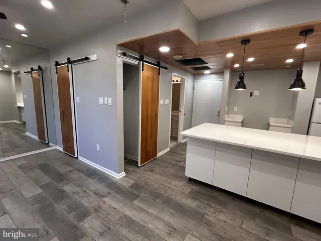 a bathroom with double vanity and a mirror