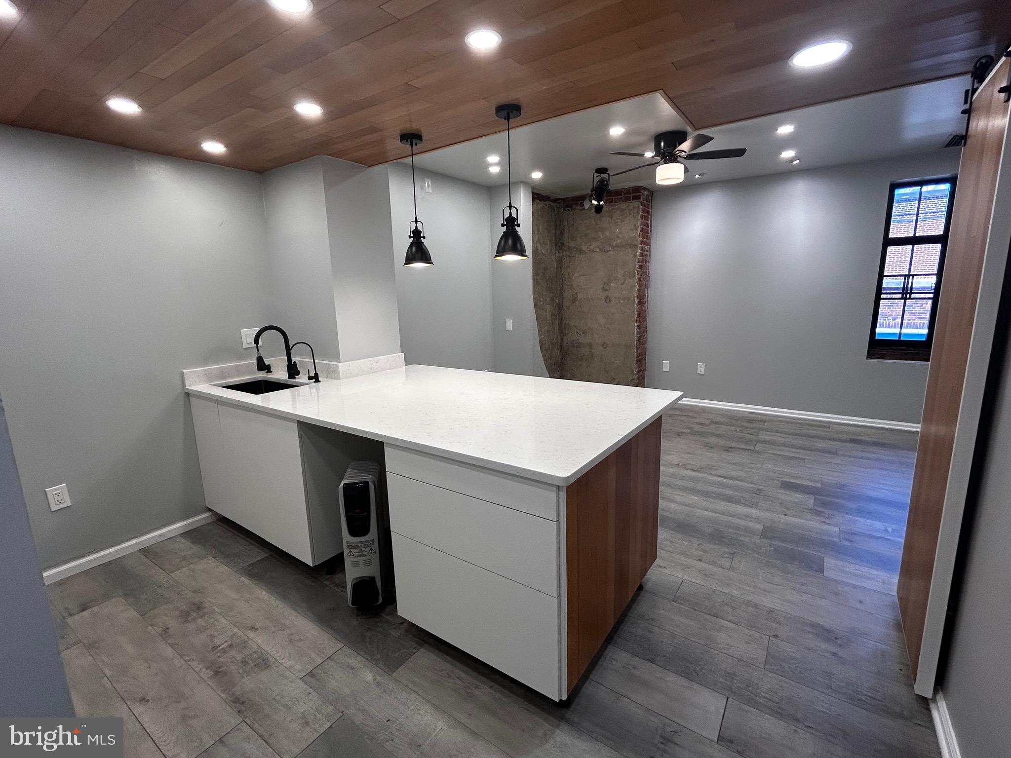 1601 Spring Garden Street, Unit 502 Philadelphia, PA 19130 - Photo 5 of 18 a kitchen with a sink and chandelier