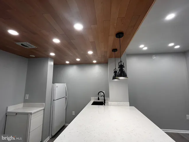 a view of a big room with closet and a chandelier