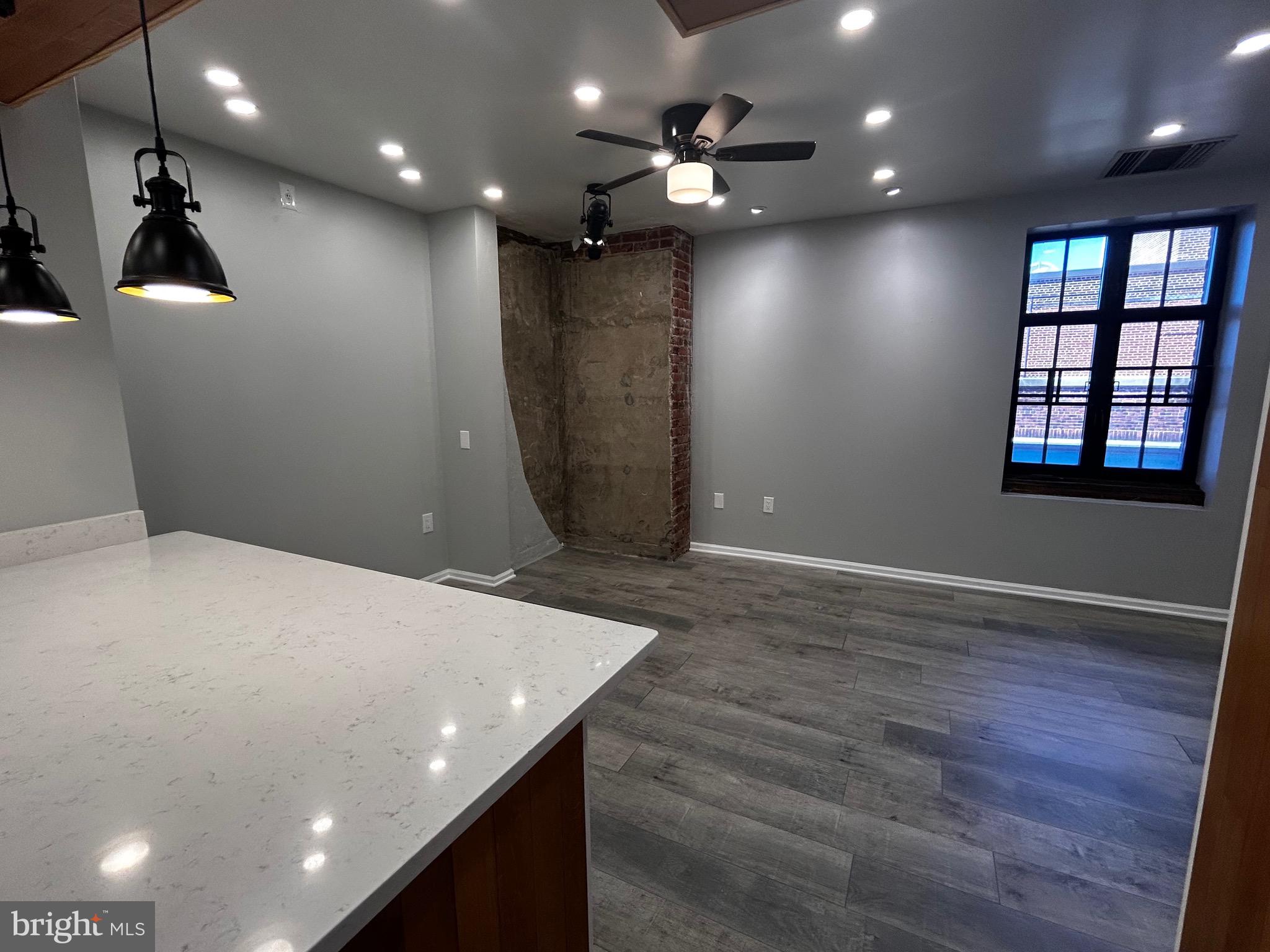1601 Spring Garden Street, Unit 502 Philadelphia, PA 19130 - Photo 9 of 18 an empty room with wooden floor and windows