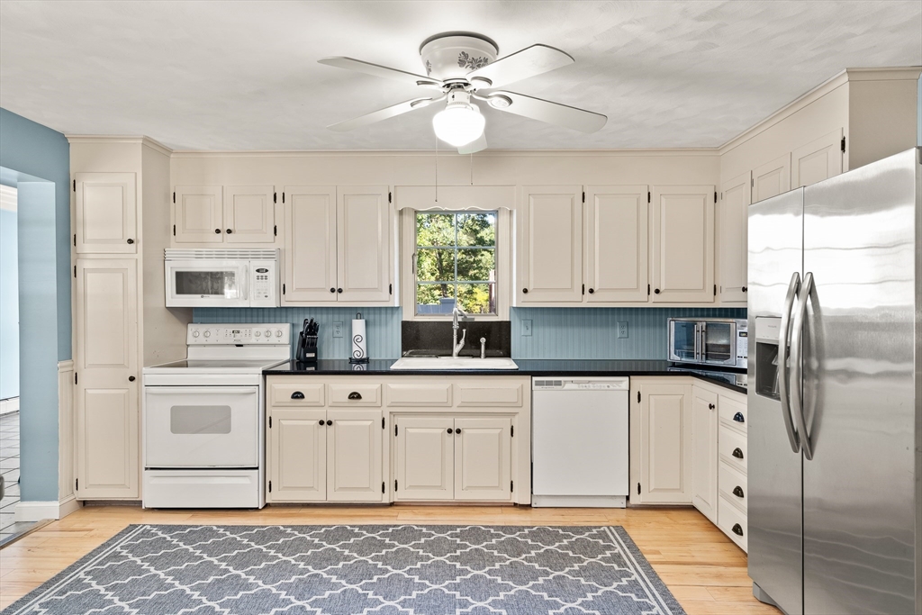 63 Pomeroy Street Easthampton, MA 01027 - Photo 14 of 42 a kitchen with white cabinets and window