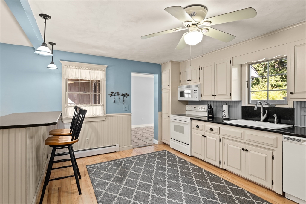 63 Pomeroy Street Easthampton, MA 01027 - Photo 15 of 42 a kitchen with stainless steel appliances a stove a sink cabinets and a window