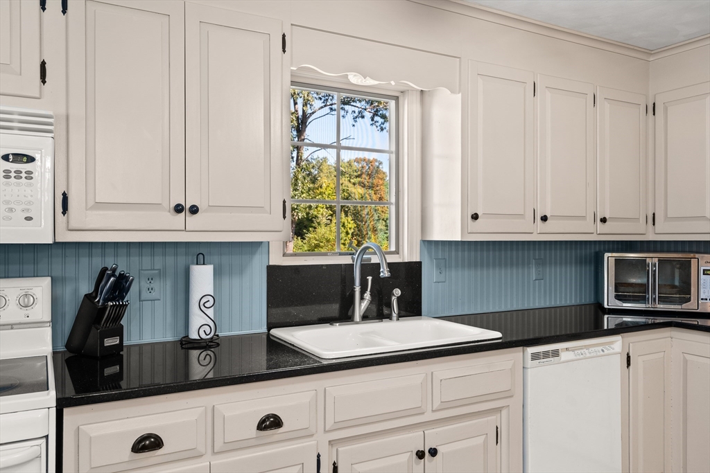 63 Pomeroy Street Easthampton, MA 01027 - Photo 16 of 42 a kitchen with white cabinets and a sink