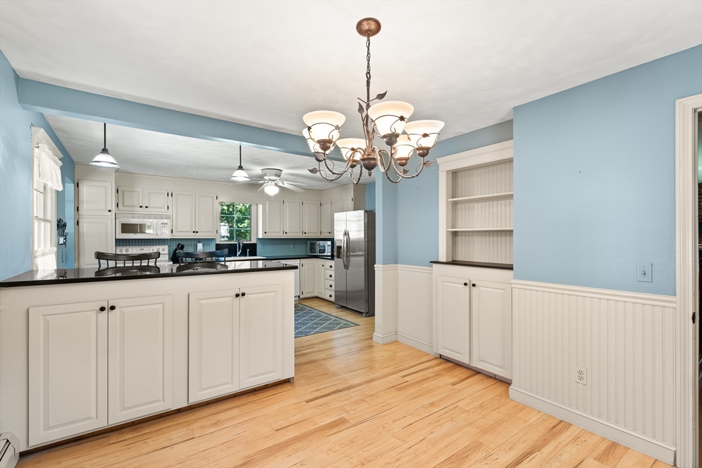 63 Pomeroy Street Easthampton, MA 01027 - Photo 19 of 42 a large kitchen with granite countertop a white cabinets and chandelier