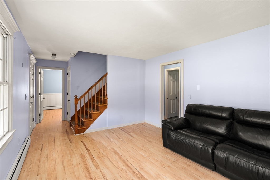 63 Pomeroy Street Easthampton, MA 01027 - Photo 24 of 42 a living room with a couch and a wooden floor