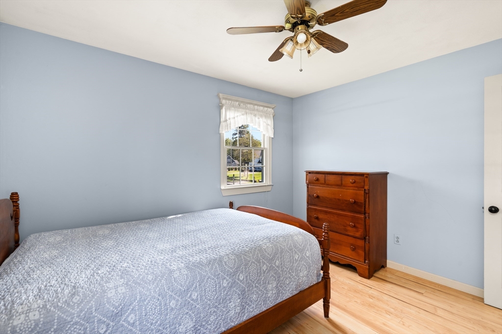 63 Pomeroy Street Easthampton, MA 01027 - Photo 27 of 42 a bedroom with a bed and a chandelier