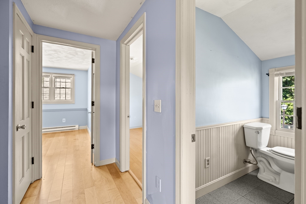 63 Pomeroy Street Easthampton, MA 01027 - Photo 34 of 42 a bathroom with a granite countertop toilet a sink and a mirror