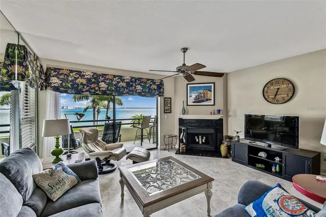 a living room with furniture a flat screen tv and a fireplace