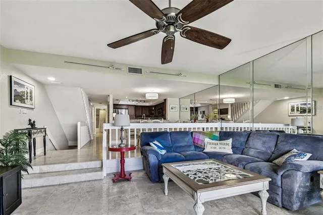 a living room with lots of furniture and a chandelier