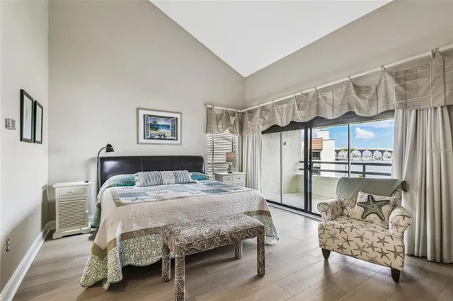 a bedroom with a bed mirror and a table