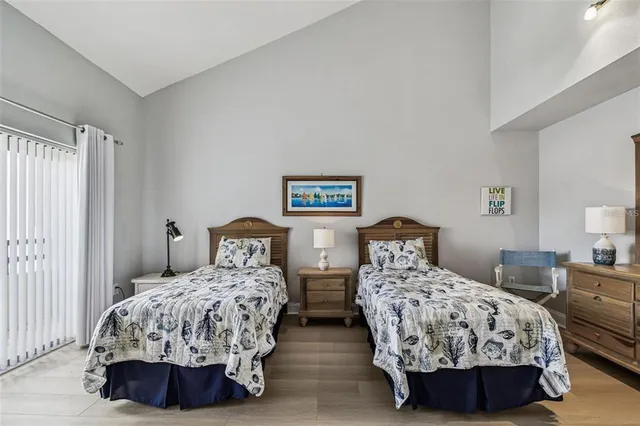 a bedroom with two beds and dresser