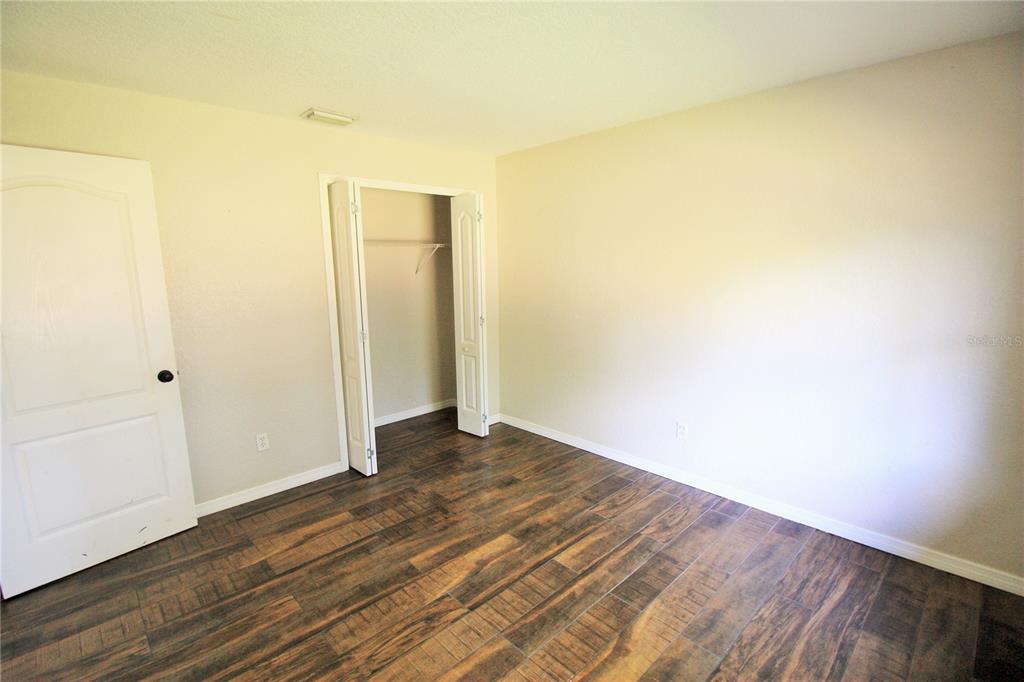6101 Southeast Foss Road, Unit 2 Belleview, FL 34420 - Photo 12 of 16 a view of an empty room with wooden floor