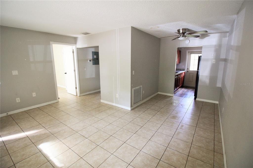 6101 Southeast Foss Road, Unit 2 Belleview, FL 34420 - Photo 6 of 16 a view of a hallway with wooden floor and staircase