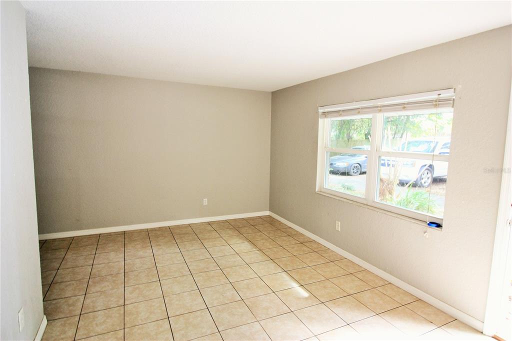 6101 Southeast Foss Road, Unit 2 Belleview, FL 34420 - Photo 9 of 16 an empty room with windows