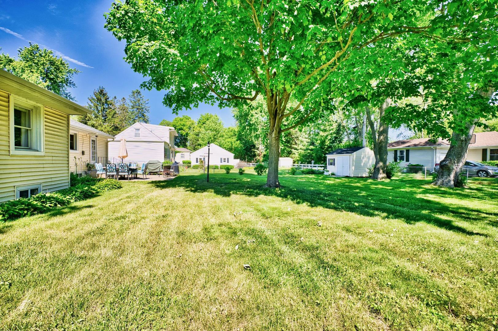 705 Carlisle Road Batavia, IL 60510 - Photo 20 of 25 a view of a house with a big yard and large trees