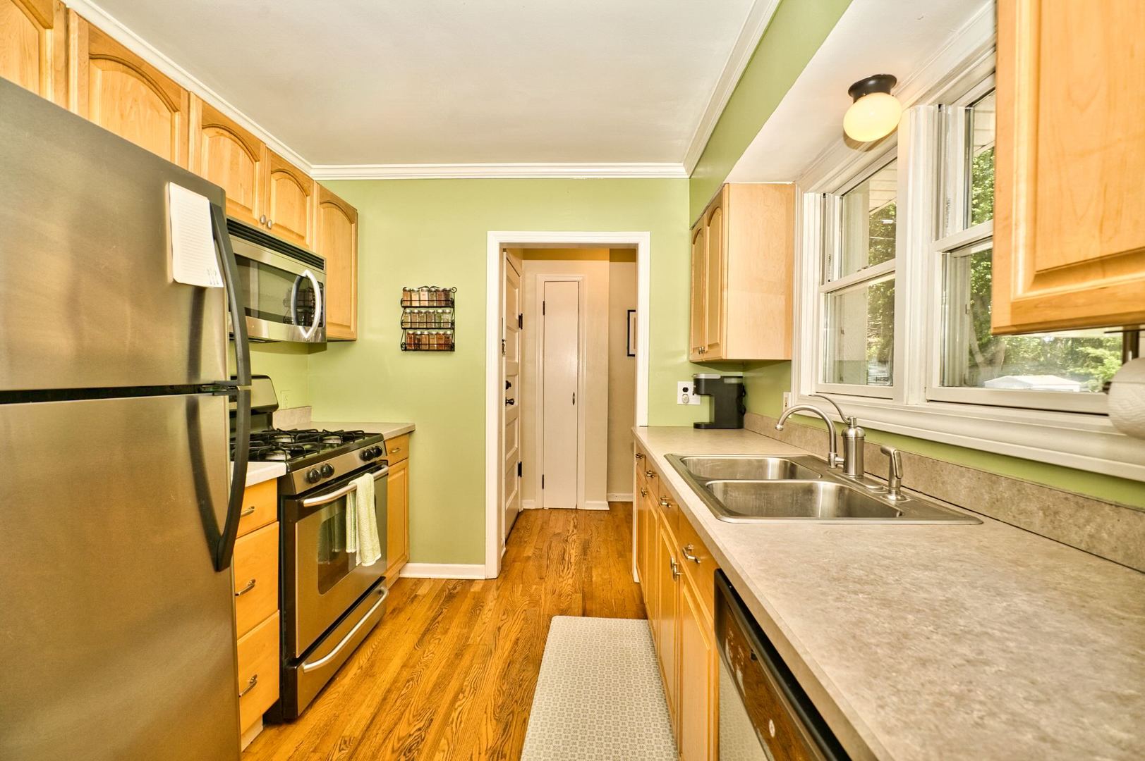 705 Carlisle Road Batavia, IL 60510 - Photo 9 of 25 a kitchen with granite countertop a sink a counter top space and stainless steel appliances
