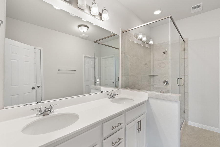 457 Elephant Island Loop Kyle, TX 78640 - Photo 16 of 30 a bathroom with a sink double vanity granite tub shower and a mirror