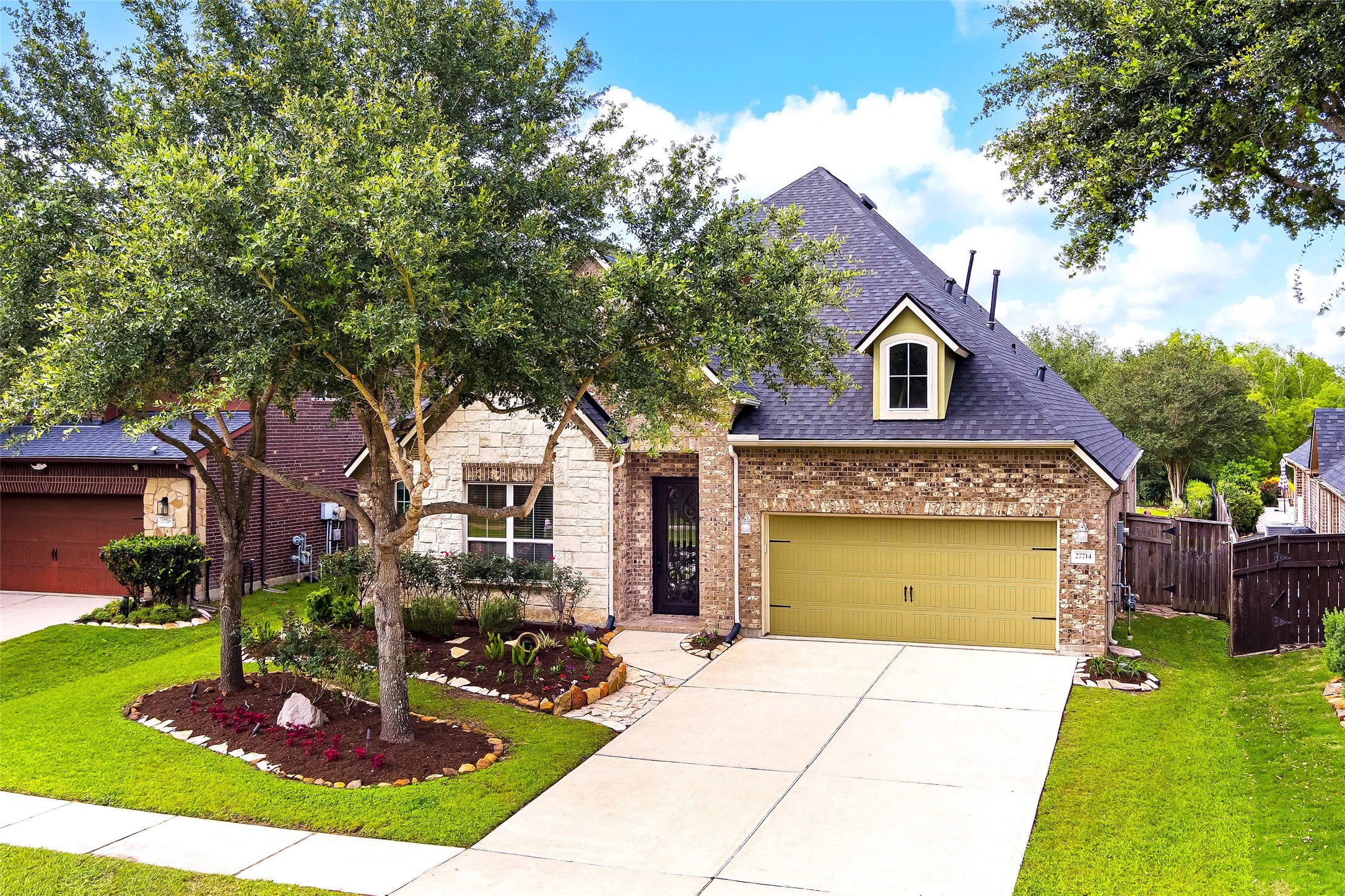 A+ Curb appeal with beautiful landscaping and a brick and stone facage
