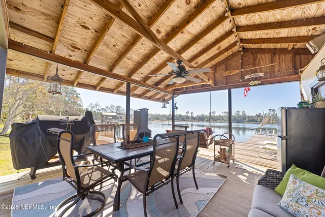 a swimming pool view with a seating space