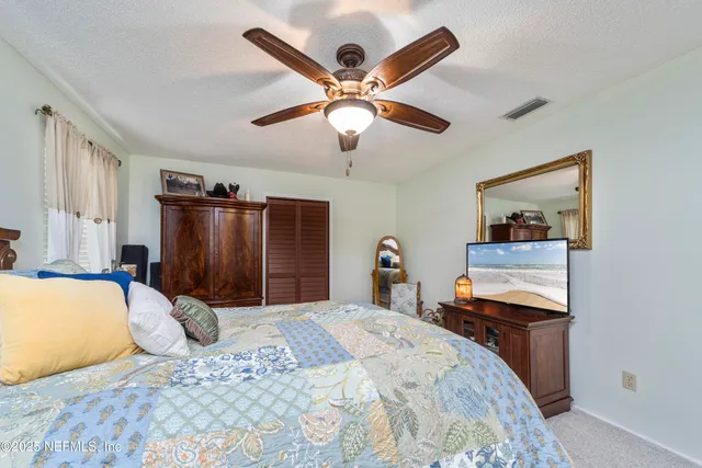 a bedroom with a bed and a mirror