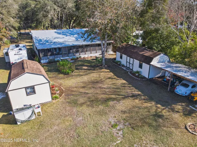 an aerial view of a house with a yard