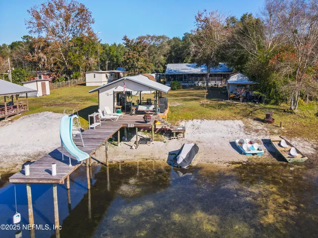 an aerial view of a house with swimming pool garden and patio