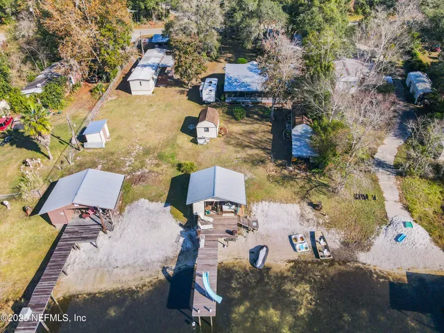 an aerial view of a house with a yard