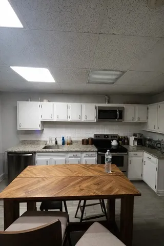 a large kitchen with a table and chairs in it