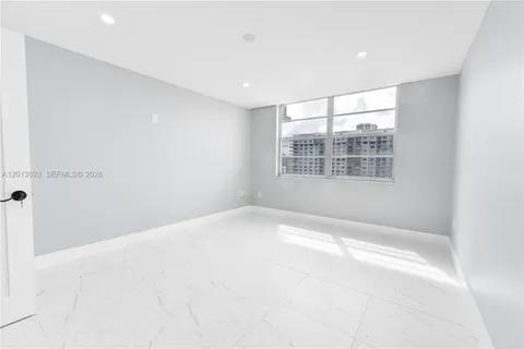 a large room with lots of furniture and a large window
