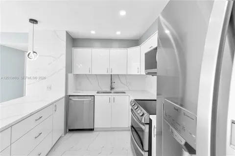 a kitchen with a sink microwave and cabinets